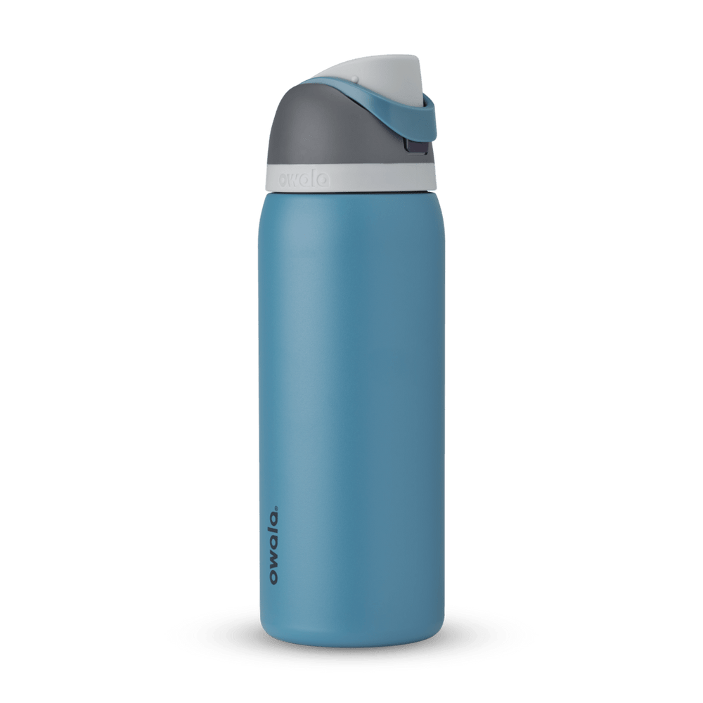 FreeSip 32oz in Blue Oasis, denim blue body with matching blue carry loop, dark gray flip cap, and white accent band